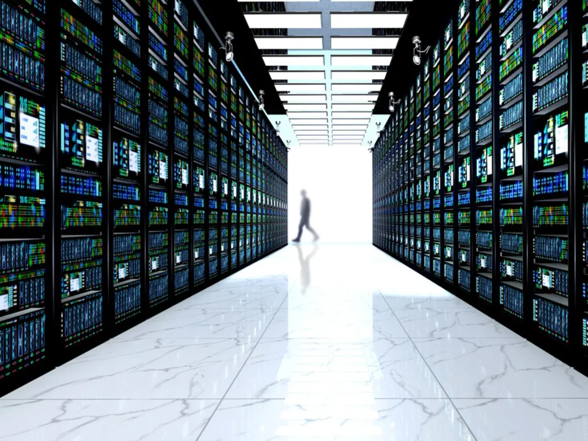 Modern data center server room with rows of network equipment racks running 100G QSFP28 optical transceivers using DML and EML laser technology